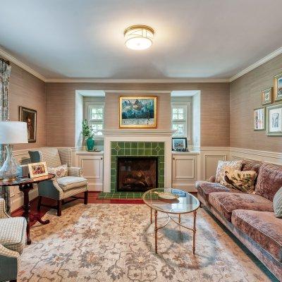 Former dining room reconfigured to living room with tile fireplace